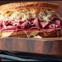 Classic Reuben Sandwich  · Rye Bread, corned beef, Swiss cheese, butter, thousand islands dressing, sauerkrauts .
