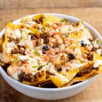 Nachos · Ground beef, chicken or pork. Tortilla chips smothered with beans, melted cheese, diced toma...