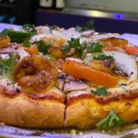 Heavenly Shrimp Pizza · Special marinera sauce, grilled shrimp, parsley, onions, tomatoes, mushrooms.