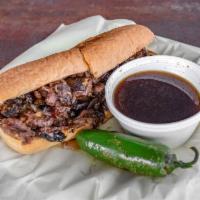 French Dip Sandwich · Thin sliced flank steak caramelized onions, portabella mushroom, and brie cheese served on a...