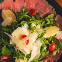 Carpaccio di Manzo · Thin slices of grass fed filet mignon dressed with fresh squeezed lemon topped with parmigia...