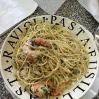Shrimp Scampi · Jumbo shrimp cooked in garlic, butter & wine sauce served over pasta .