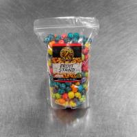 Fruit Stand Karmel Korn · Candied popcorn in a mix of six bright colors and flavors. Lemon, orange, green apple, blue ...