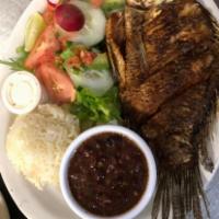 Mojarra Frita · Fried fish served with salad rice and beans.