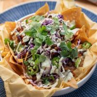 Vegan Loaded Nachos · vegan chili, vegan white cheddar, green onion, cabbage, tofu ‘sourcream' + jalapeno