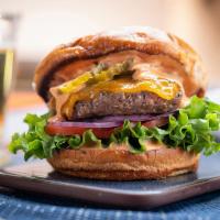 Signature Burger · 6oz burger, romaine, tomato, onion, cheebo sauce, cheddar, brioche bun.  Served medium.