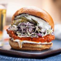 Buffalo Chicken Sandwich · country fried chicken breast tossed in buffalo sauce, slaw, lemon-herb mayo, pickles, brioch...