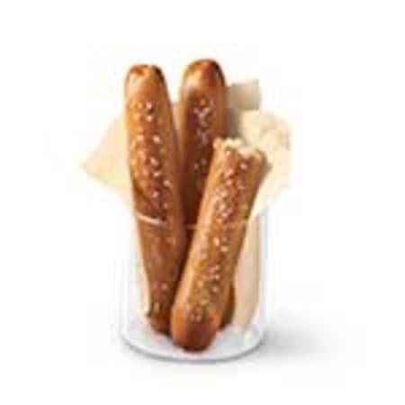 Pretzel Sticks with Zesty Queso · Soft pretzel sticks served hot from the oven and topped with salt and served with warm zesty queso dipping sauce.