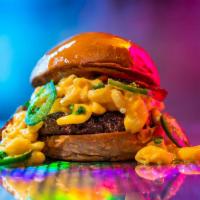 Dirty Mac Burger · 6oz signature burger patty, cheddar mac n cheese, jalapeno, bacon, brioche bun. Served medium.