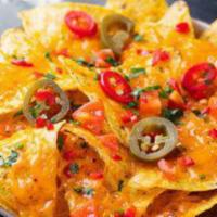 Super Nachos · Homemade tortilla chips with seasoned ground beef, cheese, tomatoes, onions, green peppers, ...