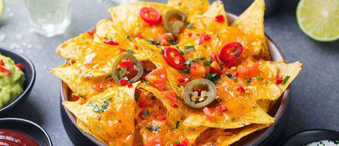 Super Nachos · Homemade tortilla chips with seasoned ground beef, cheese, tomatoes, onions, green peppers, black olives, and jalapeno. Garnished with sour cream and salsa. Substitute chicken for an additional charge.
