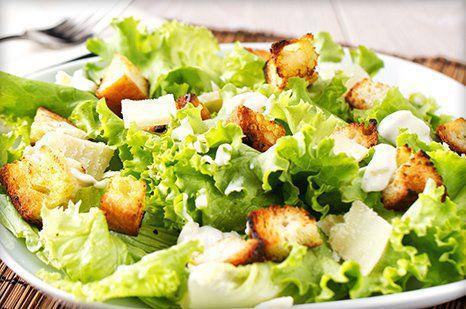 Caesar Salad · Crisp romaine lettuce tossed with creamy Caesar dressing, croutons, and Parmesan cheese. Add chicken for an additional charge.