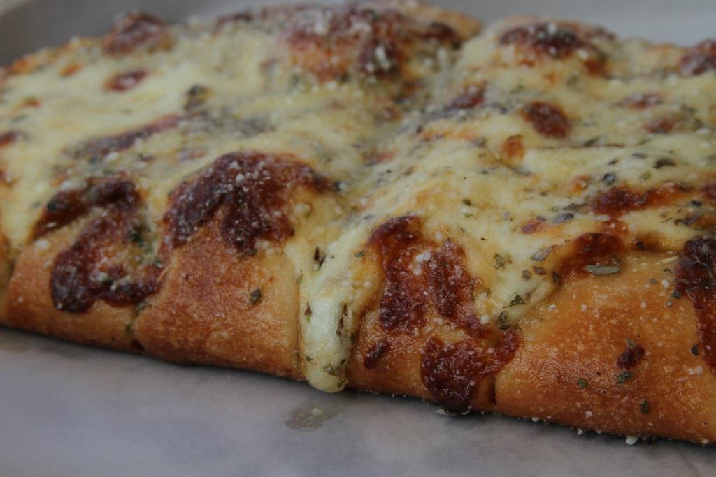 Cheesy Bread · Fresh breadsticks covered in mozzarella and Parmesan, served with marinara sauce.