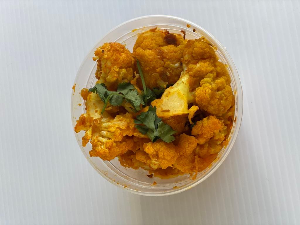 Gobhi Aloo · Fresh cauliflower and potatoes cooked with finely chopped onions, tomatoes, ginger, garlic, cumin seeds, and spices.