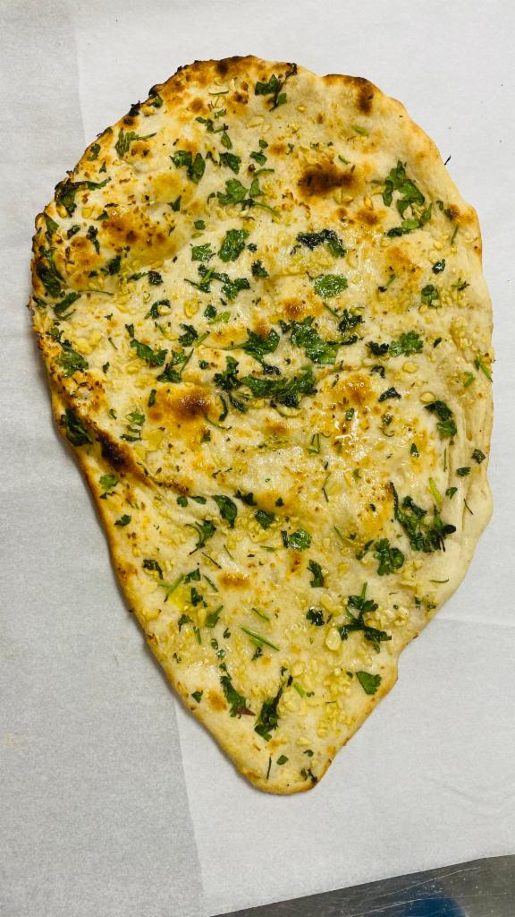 Garlic naan · Indian yeast-leavened bread, traditionally baked in clay oven with chopped garlic on top.