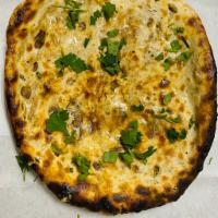 Amritsari Kulcha · Round Indian bread made with all purpose flour Stuffed with onions, potatoes made in clay ov...