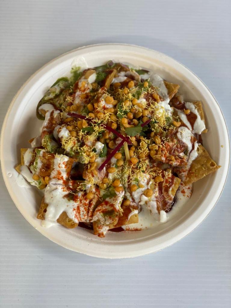 Papdi chaat · Crunchy base of papadi (crisp puris) toped with yogurt red and mint chutney potatoes chickpeas seav and spices