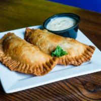 Empanada · Puff pastry stuffed with choice of ground beef, vegetables, or cheese, served with aioli sauce