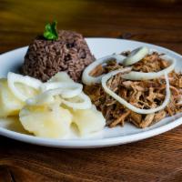 Lechon Asado · Roasted pork, serve with Moros y Cristianos, and steamed cassava with fresh garlic and oil