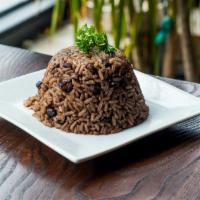 Moros y Cristianos · White rice and Black Beans cooked together in Sofrito