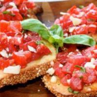 Bruschetta Toscana · Toasted bread with fresh chopped tomatoes, extra virgin olive oil, and garlic, topped with c...