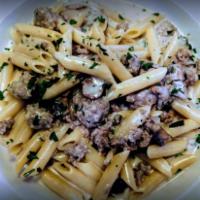 Penne alla Norcia · Tube-shaped pasta with sweet sausage, wild mushrooms, and white wine in a light cream sauce.