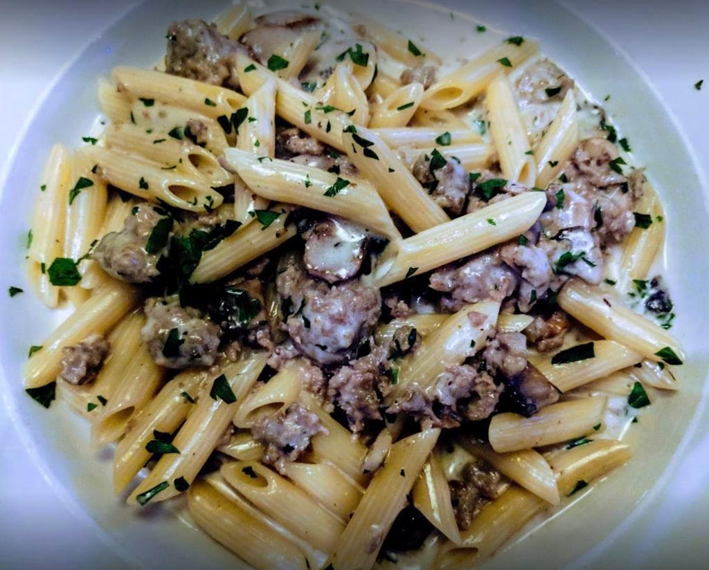 Penne alla Norcia · Tube-shaped pasta with sweet sausage, wild mushrooms, and white wine in a light cream sauce.