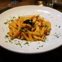 Penne alla Zarina · Penne pasta with fresh salmon and shallots in a light pink vodka sauce, topped with sturgeon...