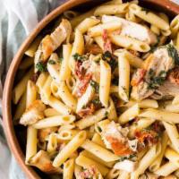 Pennette con Pollo · Penne pasta with chicken, sun-dried tomatoes, mushrooms, and zucchini in a light cream sauce.