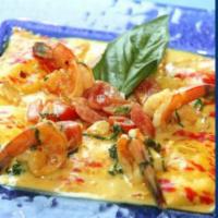 Ravioli alla Caprese con Gamberoni · Homemade ravioli stuffed with ricotta cheese and herbs served with fresh rock shrimp and bel...