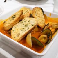 Cioppino alla Livornese · Traditional Italian stew served with mussels, clams, fresh catch of the day, calamari, scall...