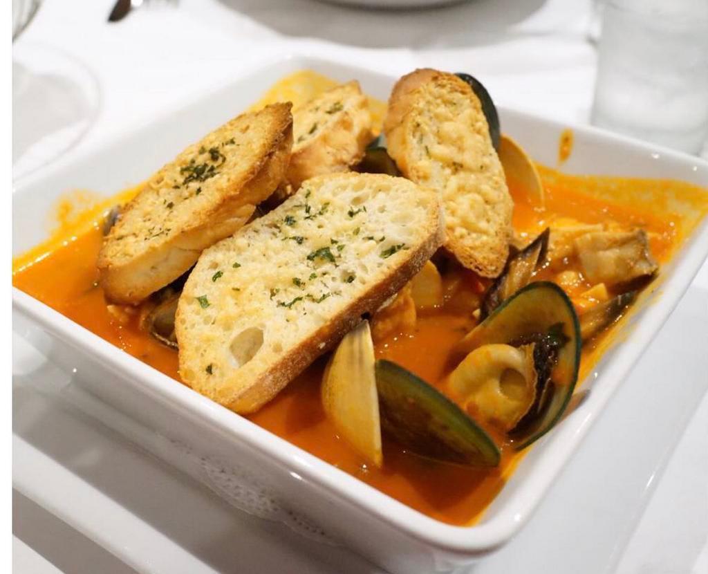 Cioppino alla Livornese · Traditional Italian stew served with mussels, clams, fresh catch of the day, calamari, scallops, and shrimp in a light tomato broth, served with toasted ciabatta bread.