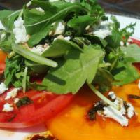 Insalata Tricolore · Fresh sliced tri-color heirloom tomatoes, spring mix, olives, red onions, oregano, and extra...