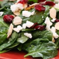 Insalata di Spinaci · Baby leaf spinach, Montrachet cheese, dried cherries, mushrooms, tomatoes, and ginger-carame...