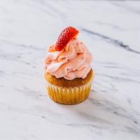 Strawberry Lemonade Cupcake · Lemon cupcake with strawberry buttercream topped with a fresh strawberry.