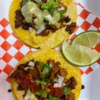 Al pastor tacos · Slowly braised Al pastor. Topped with onions cilantro salsa.
