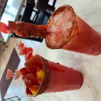 Frozen Strawberry Lemonade · Made in house with fresh strawberries and Lemons. Tajin and Chamoy on the rim. Topped wit Me...