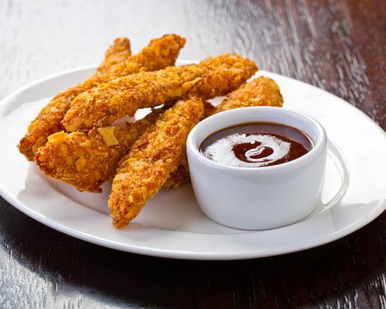 Chicken Fingers · Fresh batch of chicken fingers served with celery, carrots, and honey mustard.