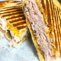 13. Monte Cristo Panini · Layers of ham and smoked turkey, Swiss, cheddar cheese, lettuce, tomatoes and honey mustard....