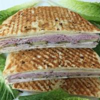 3. Combination Panini · Corned beef, turkey, Swiss cheese, coleslaw, Russian dressing, lettuce and tomatoes. Hot gri...