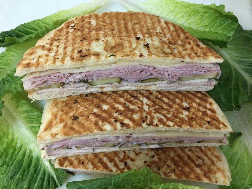 3. Combination Panini · Corned beef, turkey, Swiss cheese, coleslaw, Russian dressing, lettuce and tomatoes. Hot grilled sandwich on European flat bread served with chips and pickle.