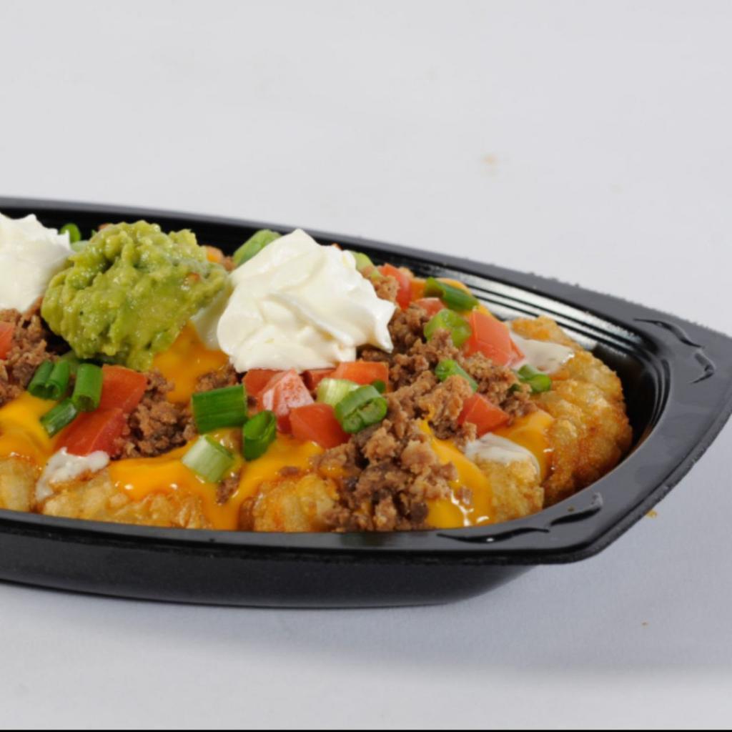 Mexi Fry Nacho · Golden, crisp Mexi fries covered with refritos, ranch dressing, cheese sauce and seasoned ground beef topped with tomatoes, green onion, sour cream and guacamole.