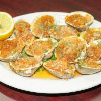 Baked Clams · Minced clams mixed with butter, onions, parsley and bread crumbs, stuffed into a half clam s...