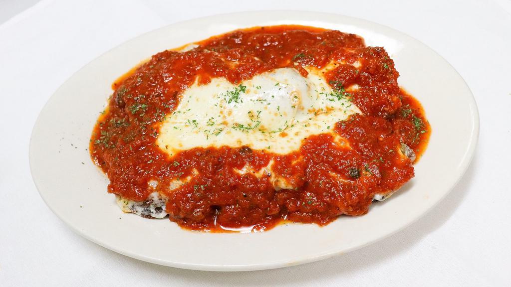 Eggplant Parmigiana · Fresh slices of eggplant, lightly breaded and fried, then layered with ricotta cheese, mozzarella and tomato sauce. Baked until golden brown. Served with your choice of pasta or salad. 