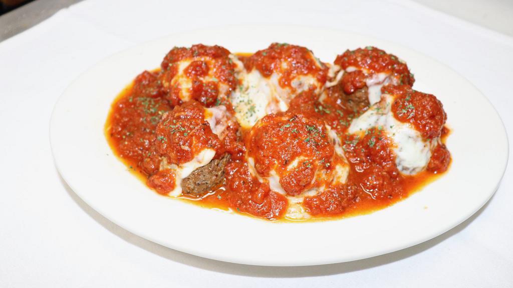 Meatball Parmigiana · Our homemade, broiled beef meatballs, baked with mozzarella cheese and tomato sauce. Served with your choice of pasta or salad. 