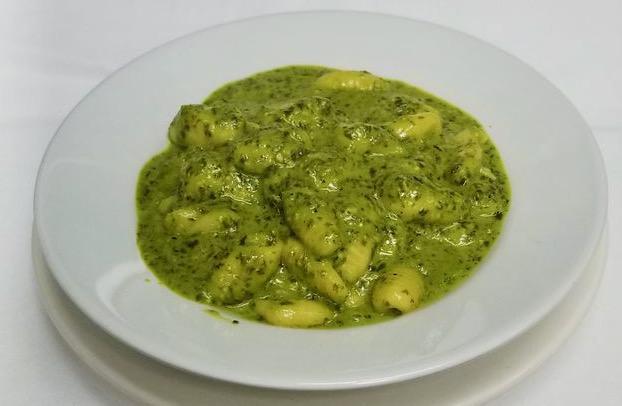 Gnocchi Al Pesto · Light, potato pasta dumplings, served in a homemade pesto sauce made from basil, garlic, pine nuts, olive oil and Parmesan cheese. 