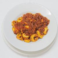 Tortellini with Meat Sauce · Cheese filled rings of pasta (tortellini) served in homemade sauce of seasoned ground beef f...