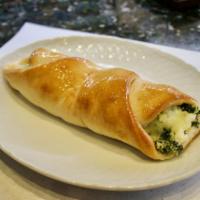 Spinach Roll · Pizza dough is wrapped around mozzarella and chopped spinach, then baked. The ends are left ...