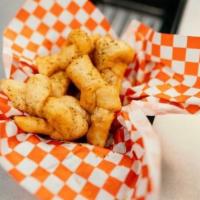 Garlic Knots- 16 Pack · Delicious pizza dough knots deep fried, topped with butter and seasoning served with marinar...