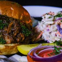 Pulled Pork Sandwich · Loaded slow cooked pulled pork on a brioche bun served with hour homemade coleslaw